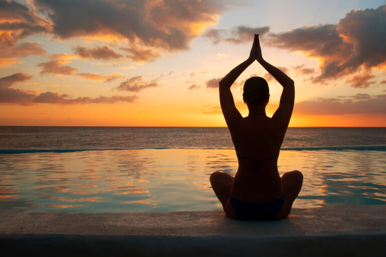 Woman,Meditating,At,Sunset